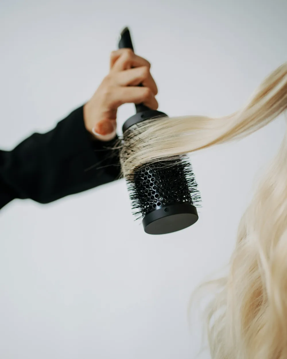 A round brush through lightened hair