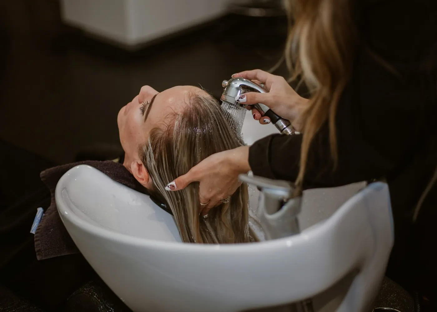 Hair being rinsed at a salon basin
